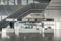 the interior of an office building with white desks and metal stairs leading up to it