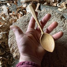 a person holding a wooden spoon in their hand