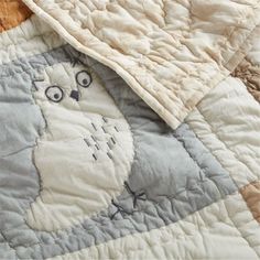 an animal themed quilt on top of a bed