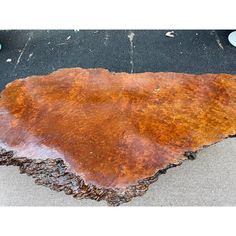 a large piece of wood sitting on the ground