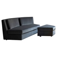 a black couch and ottoman sitting next to each other