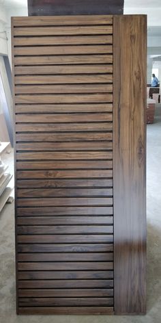 a large wooden slatted door in a room