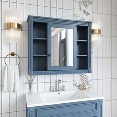 a bathroom with blue cabinets and white tiles