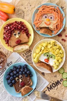 four plates with food shaped to look like people's faces and vegetables on them