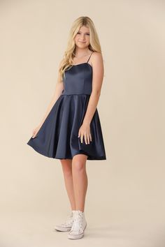 Blonde girl in a Un Deux Trois fit and flare navy satin dress. Teenage Dress Outfits, Teen Bday Dress, Short Formal Dresses For Teens 8th Grade, Teen Semi Formal Dresses, Culmination Dresses, Pre Teen Dresses, Wedding Guest Dress Teenager, Year 6 Graduation Dresses