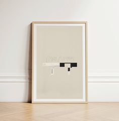 a framed artwork piece on the wall next to a wooden floor with a white background