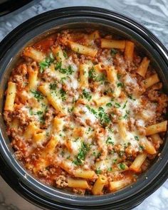 a crock pot filled with pasta and meat