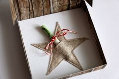 a star shaped ornament in a box on a table