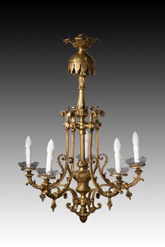 an antique brass chandelier with five candles