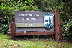 the sign for leadbetter point state park is posted in front of some trees