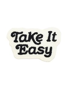 a black and white patch that says take it easy