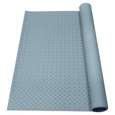 a roll of blue plastic sheet with diamond pattern on the top and bottom, in front of