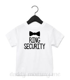 a white shirt with the words ring security on it and a bow tie hanging from a hanger