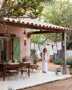 a woman standing in front of a house