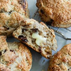 muffins with butter and raisins sitting on a cooling rack, ready to be eaten