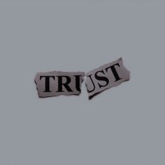 two torn pieces of paper that say trust and trust