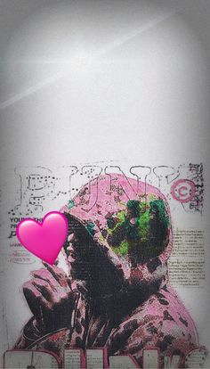 a pink heart sitting on top of a white wall next to a drawing of a man's head