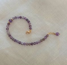 Amethyst Bracelet Natural Stone Bracelet Purple Bracelet This beautiful bracelet is made of natural amethyst crystal beads. The beads are 4 mm in diameter and one bead is 6 mm in diameter and is located on one side of the bracelet along with the brass gold beads. At the end of the bracelet is a gold brass clasp and a small extension of 2 cm to adjust the length. At the end of the extension is a pendant amethyst pearl. The bracelet is elegant and can be a wonderful gift for your love, for your mo Turquoise Jewelry Boho, Jewelry 2022, Amethyst Bracelet Beads, Gift Valentines Day, Turquoise Bead Bracelet, Purple Bracelet, Coral Bracelet, Natural Stone Bracelets, Bracelet Gemstone