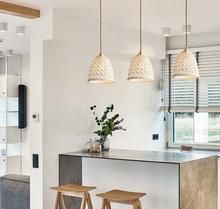 a kitchen with three stools next to an island