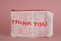 a red and white thank you pouch on a pink background