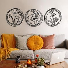 three circular metal wall art pieces above a couch in a living room with coffee table