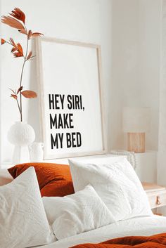 a bed with white sheets and pillows in front of a framed poster that says hey girl, make my bed