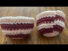 two crocheted balls sitting on top of a wooden table