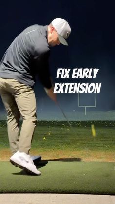 a man hitting a golf ball with a club on the green grass and an advertisement that reads fix early extension