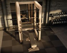 a gym with an exercise bench and squat machine