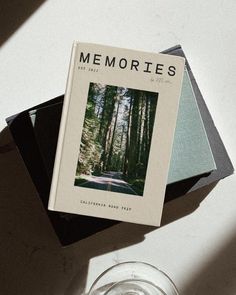 a book sitting on top of a white table next to a glass filled with water