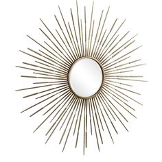 a gold sunburst mirror on a white wall