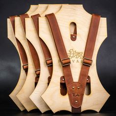 four pieces of wood with leather straps on them