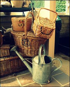 an old watering can and some wicker baskets