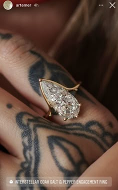 a close up of a person's hand with tattoos on it