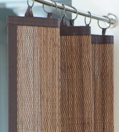 a close up view of a curtain with brown trim