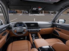 the interior of an suv with tan leather seats and dashboards, including steering wheel