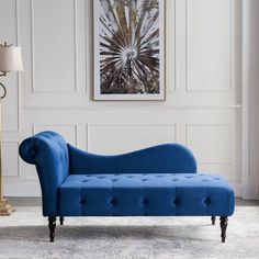 a blue couch sitting next to a lamp in a living room