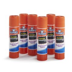 four orange and blue bottles of emer's school glue on a white background