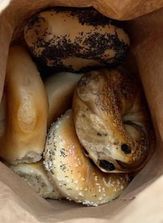 several bagels in a brown paper bag