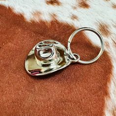 a metal object sitting on top of a cowhide rug in the shape of a heart