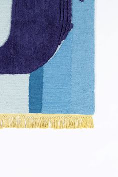 a blue and white rug with an elephant on it's side, against a white background