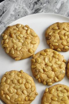 four cookies on a white plate with peanut butter