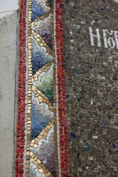 there is a very colorful mosaic on the side of a building