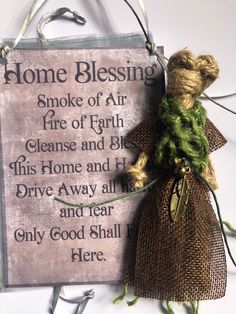 there is a sign that says home blessing and a stuffed animal in front of it