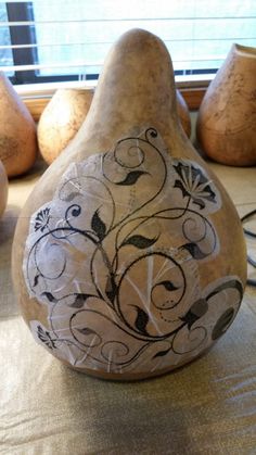 some pears are sitting on a table next to vases and other decorative items