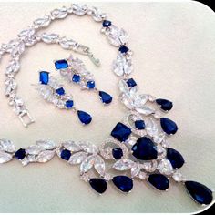 This Breathtaking Blue Sapphire Bridal Necklace And Earring Set Will Add Red Carpet Glamor To Your Wedding Ensemble. This Lavish Jewelry Set Is For The Bride Who Loves Attention Getting, Head-Turning Bling In A Luxury Design! Blue Sapphire Jewelry Set, Gala Jewelry, Capricorn Pendant, Aquarius Pendant, Sapphire Jewelry Set, Lavish Jewelry, Chain Link Necklace Silver, Blue Sapphire Jewelry, Vintage Rhinestone Necklace