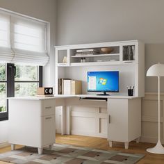 a desk with a computer on top of it in front of a window and bookshelf