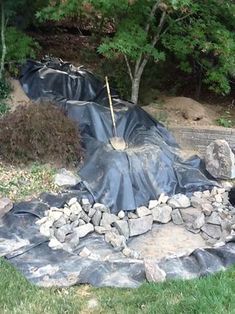 a pile of rocks sitting on top of a field next to a fire hydrant