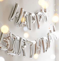 two balloons that say happy birthday hanging on a wall