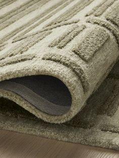 a close up view of the corner of a rug with an area rug on it